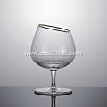 Slanted tumbler glass with gold rim